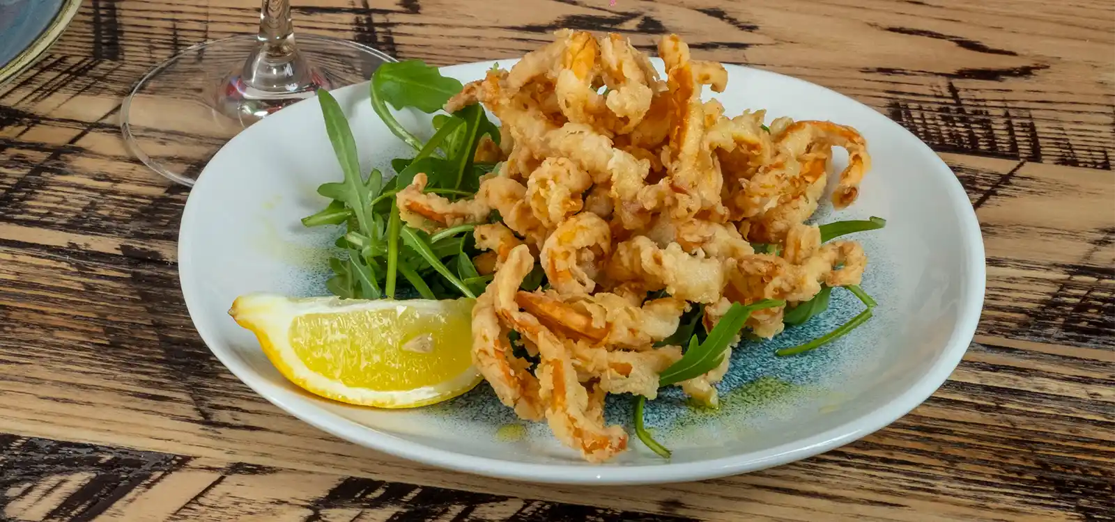 The Best Calamari in Manchester is the culinary term for squid. A slightly sweet, neutral-tasting seafood, calamari is often associated and used interchangeably with the dish “fried calamari,” which is made from the body of squid (and sometimes the tentacles) that is cut into rings, breaded, and deep fried. Occasionally, though, calamari can be sautéed or grilled.