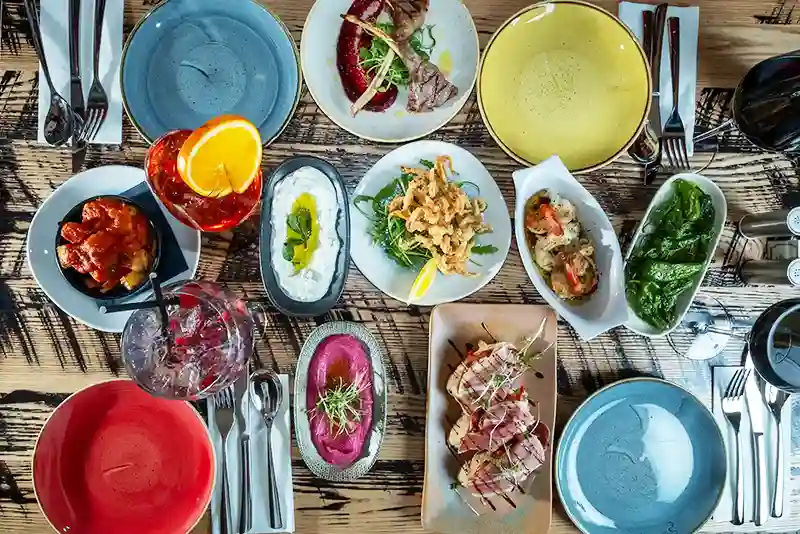 Variety of tapas dishes on a wooden table at a popular Manchester restaurant